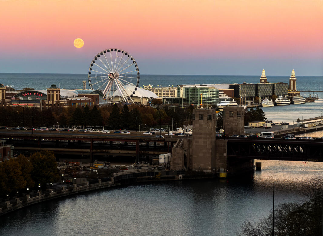 Navy Pier in Chicago, Illinois during sunset with the moon visible.